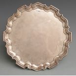 Walker and Hall George VI hallmarked silver salver with shaped edge raised on three scroll feet,