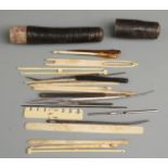 19thC sewing set in card tubular case, comprising needles, hooks etc, length of case 20cm