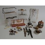 A collection of costume jewellery including brooches, silver earrings, Miracle brooch, necklaces,
