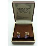 A pair of 9ct gold earrings set with a heart cut amethyst to each