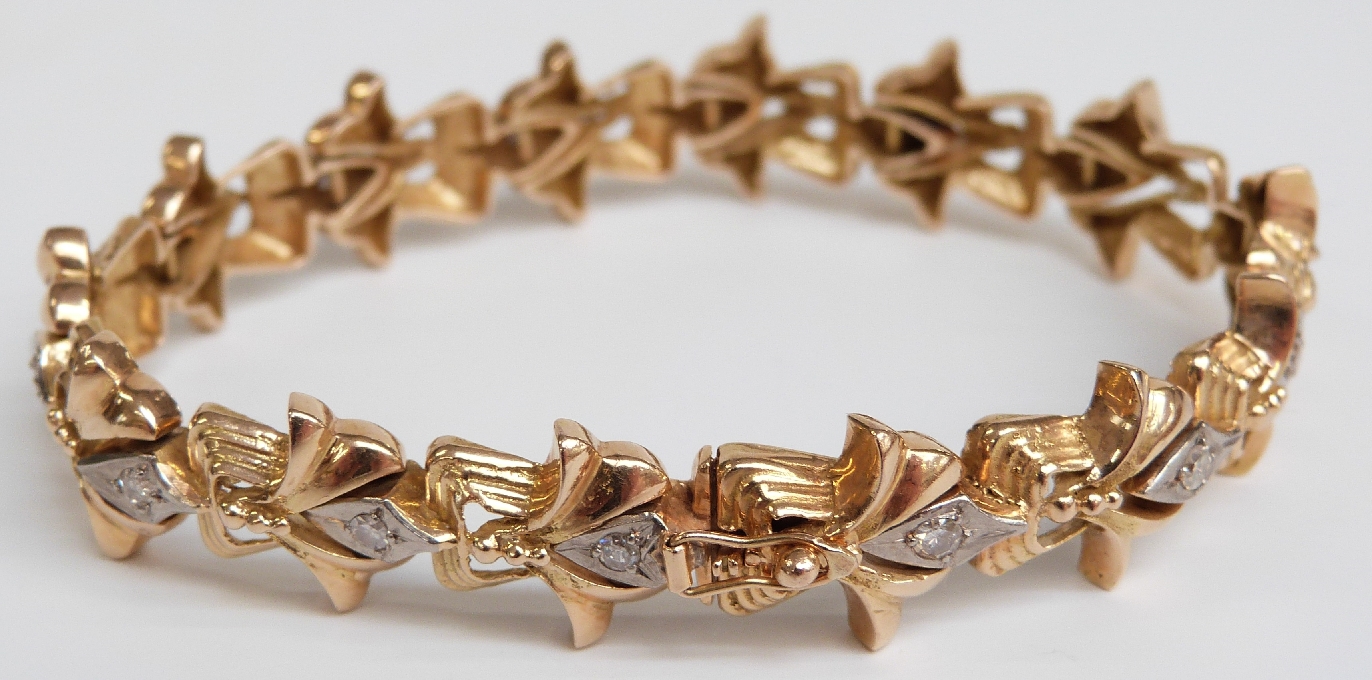 An 18ct bi-coloured gold bracelet set with 14 diamonds, each approximately 0.07ct, 28.1g
