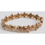 An 18ct bi-coloured gold bracelet set with 14 diamonds, each approximately 0.07ct, 28.1g