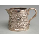 Indian or similar white metal jug with embossed decoration, height 7cm weight 106g