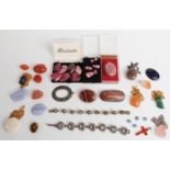 A collection of polished agate jewellery and samples.