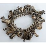 Silver charm bracelet including weather vane, space shuttle, cat, rocking horse and other charms