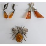 A pair of silver earrings set with pressed amber, a novelty insect brooch set with pressed amber etc