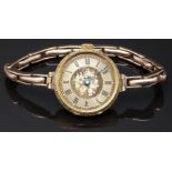18ct gold ladies wristwatch with blued hands, black Roman numerals, engraved self coloured dial,
