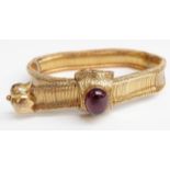 An early Victorian bracelet set with a foiled garnet cabochon to the engraved foliate clasp, 20.7g