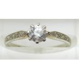 An 18ct white gold ring set with a cubic zirconia and diamonds to the shoulders, 1.7g, size L