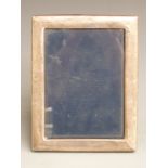 Modern hallmarked silver photograph frame to suit 7x5 inch photo, with velvet easel back,