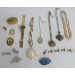 A collection of costume jewellery including a Scottish style silver pendant, brooches, mother of