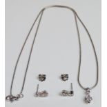 An 18ct white gold necklace set with a pear cut diamond of approximately 0.45ct and a round cut