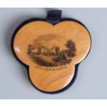 Mauchlinware pin cushion of trefoil form depicting Chillingham Castle and marked 'made of wood grown