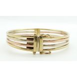 A 9ct tri-coloured bangle, 19.9g, 6 x 5.3cm