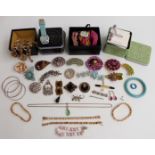 A collection of costume jewellery including vintage brooches, Art Deco brooch, silver bracelets,