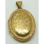 A 9ct gold locket with engraved decoration, 13.4g