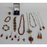 A collection of silver and pressed amber jewellery including bracelets, pendants, earrings etc