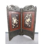 An early 20thC carved wood, mother of pearl, bone and lacquer Shibayama bifold screen, full