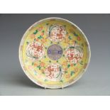 A 19thC Chinese famille jaune plate with four circular panels depicting dragons and six character