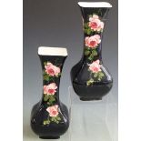 A pair of Bristol/ Pountney George Stewart vases, hand painted with cabbage roses on a blackground