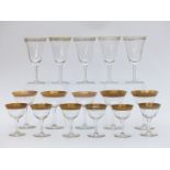 Seventeen Moser drinking glasses, all with floral decoration to the gilt rims and gilt feet,