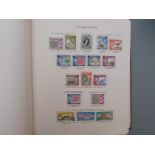 An extensive collection of QEII Commonwealth stamps in nine New Age albums, mainly used with many