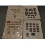 A selection of early European stamps on loose album sheets, including Danzig, Latvia, Saar and