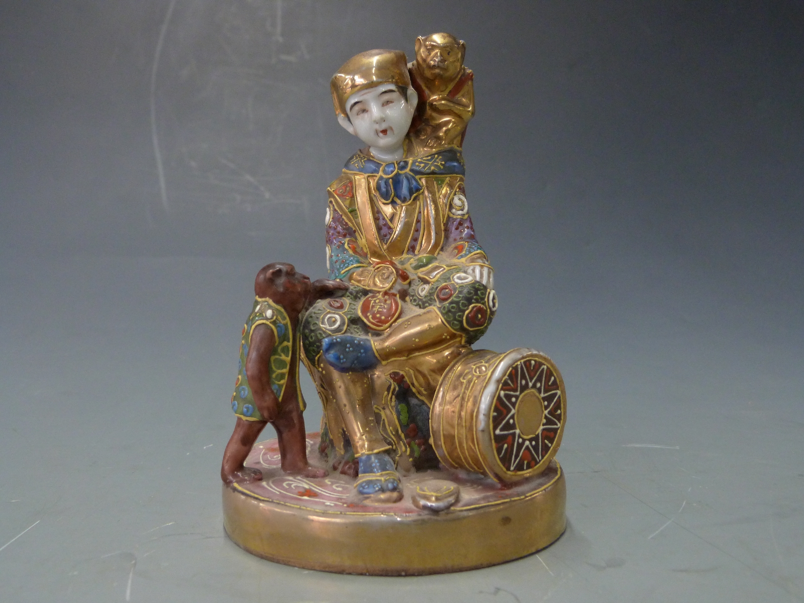 Early 20thC Japanese figure with monkeys, H13cm