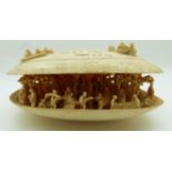 19thC Chinese carved ivory oyster shell, the interior containing many figures, trees, cart and