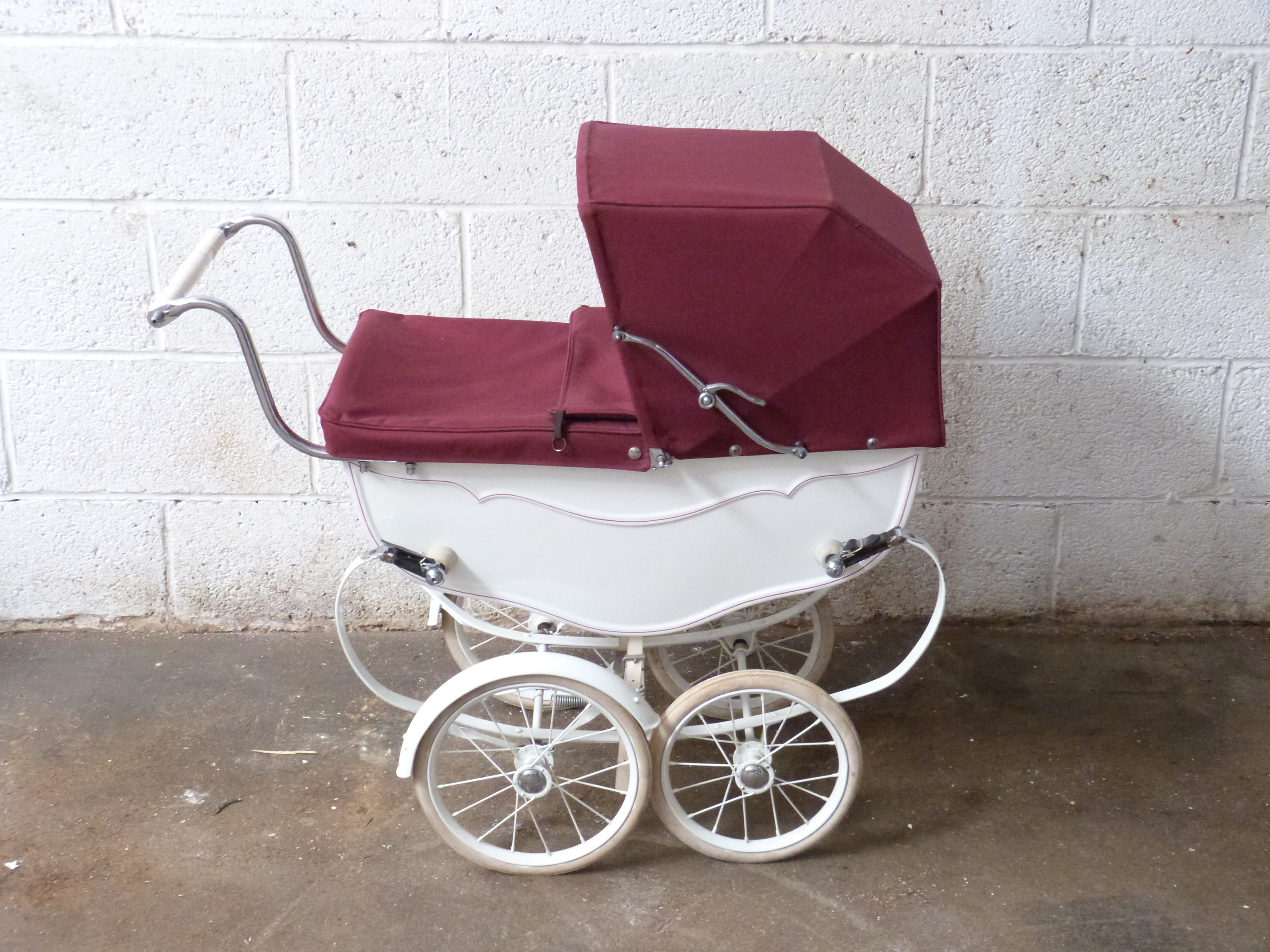 Silver Cross coach built dolls pram with maroon hood, cover and white mudguards to rear wheels,