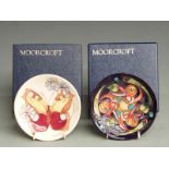 Two Moorcroft pin dishes in boxes, one signed and dated 2002, the other 1993 diameter 12cm