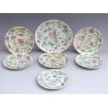 Seven Chinese Canton famille rose plates each decorated with birds, butterflies and flowers, largest