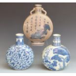Two Chinese blue and white moon flasks and a Chinese crackle glaze moon flask with script and