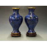 A pair of Japanese cloisonné vases on hardwood stands, 34cm tall