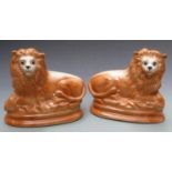 Pair of Staffordshire lions with glass eyes, H25 x L28cm