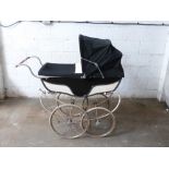 Marmet coach built pram with sprung suspension, navy and cream coachwork and hood, height to