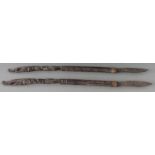 Pair of African carved hardwood slashing or skinning knives with branded wire work decoration, L55cm