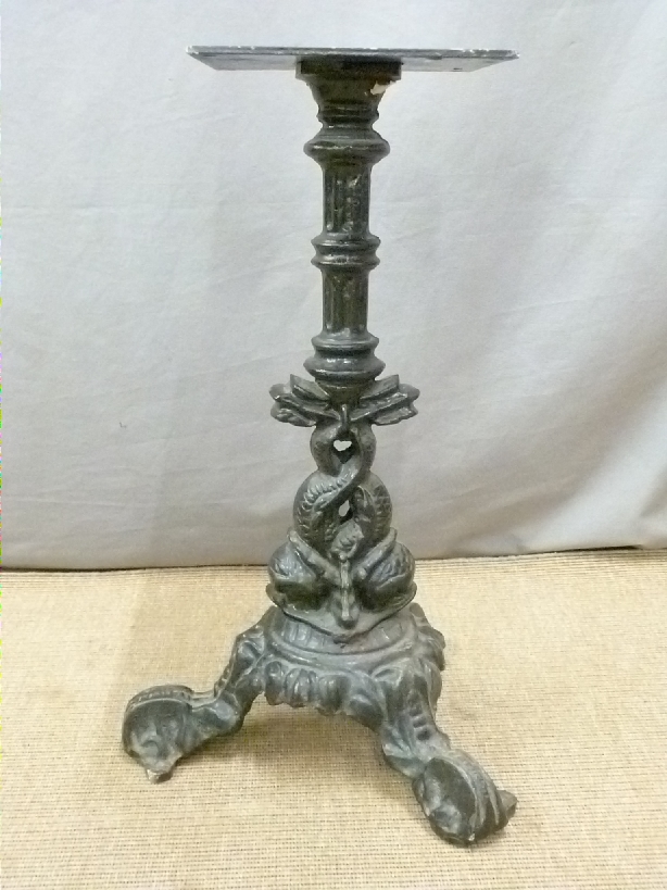 Pub table with cast iron base decorated with dolphins and a further similar base