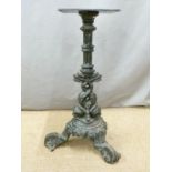 Pub table with cast iron base decorated with dolphins and a further similar base