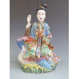 19th/20thC Chinese polychrome figurine astride a bird holding a scroll in its beak, height 27cm