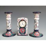 Moorcroft clock and candlestick garniture in the Mackintosh pattern, tallest 21cm