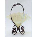 Vaseline glass handkerchief centre piece mounted on a wrought iron frame in the form of a basket,