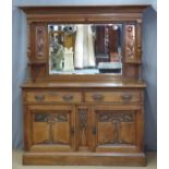 Art Nouveau oak sideboard with bevelled mirror back flanked by embossed hammered copper panels,