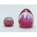 Peter McDougall glass paperweight with red and white latticino rods and central millefiori canes,