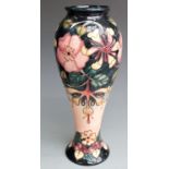 Moorcroft signed pedestal vase decorated with flowers and dated 1993, boxed, H28cm