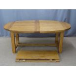 A contemporary light oak oval dining table with two additional leaves, max L 272 min 192 x W110 x