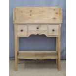 A small pine wash stand with three drawers, under shelf and gallery back, W76 x D38 x H100cm