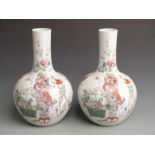 A pair of Chinese bulbous pedestal vases with floral, bat and peony decoration and Qianlong mark