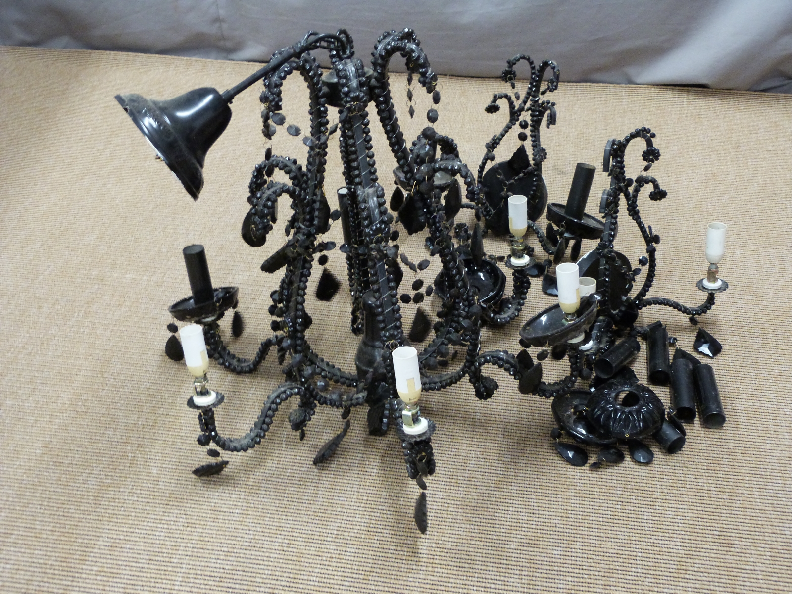 Black chandelier and matching pair of wall lights, all with cut glass style drops, height of