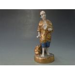 Early 20thC Japanese figure of man with rabbits, H18cm